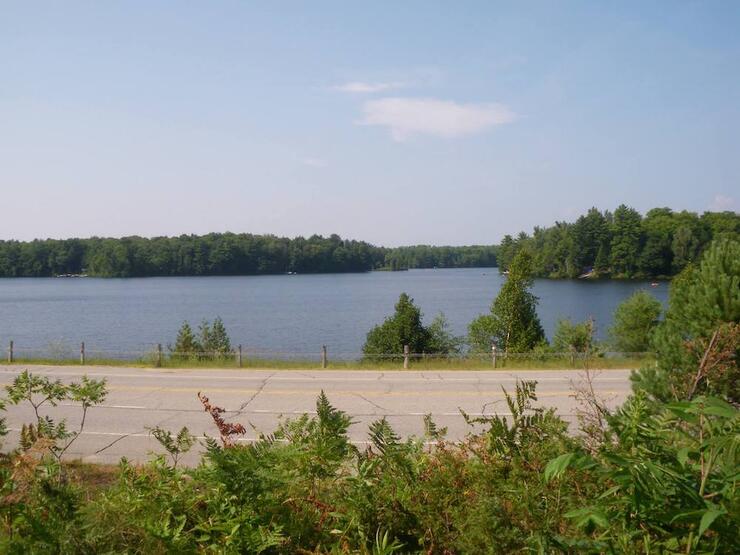 Country highway following along the side of a waterway