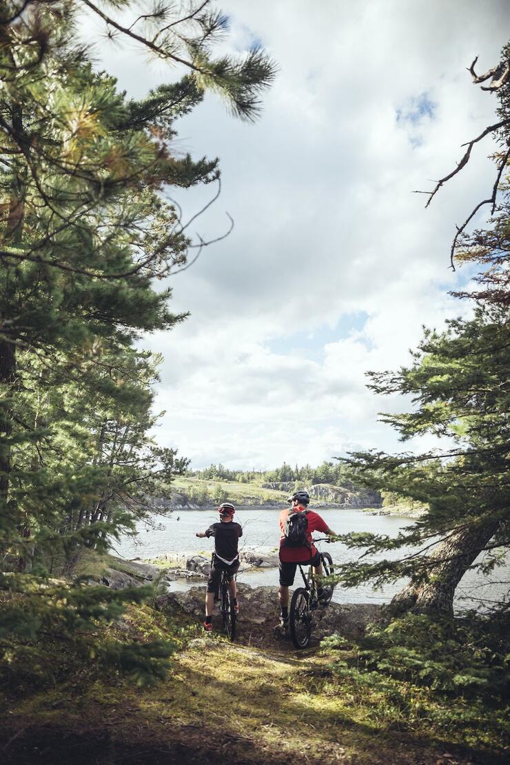 Two people biking in the woods