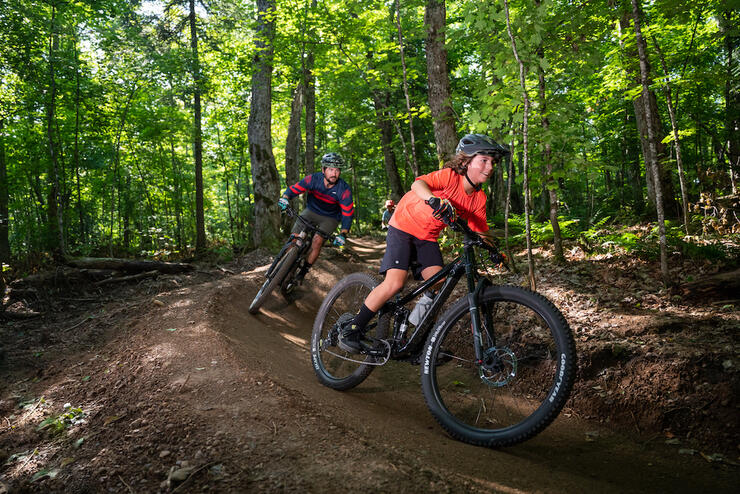 Family ride along a forest mountain bike trail