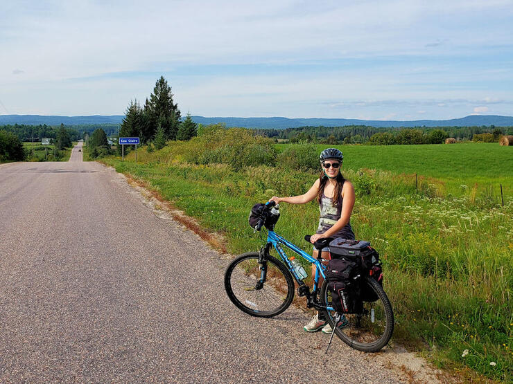 Woman poses with bicycle on the Voyageur Cycling Route