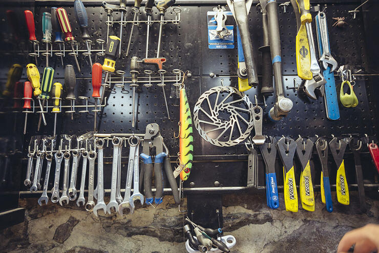 Pegboard with a selection of tools at a bike shop