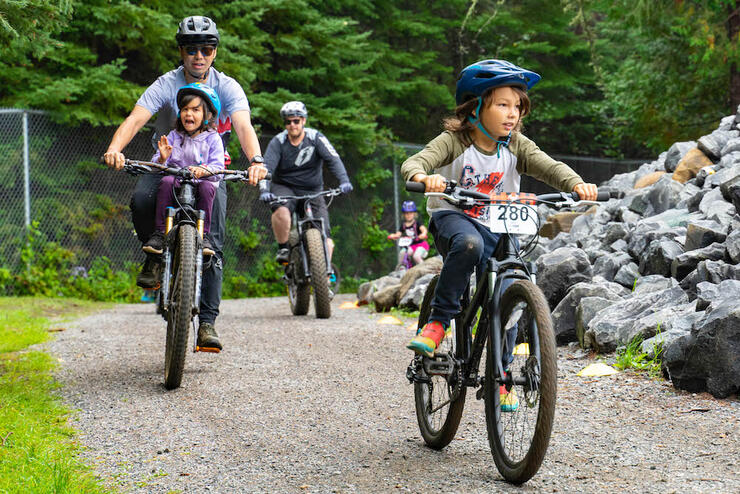 family rides together during an offroad bike race