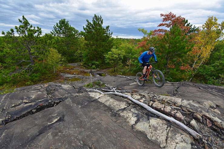 man rides over rocky outcropping at Walden Trails Park