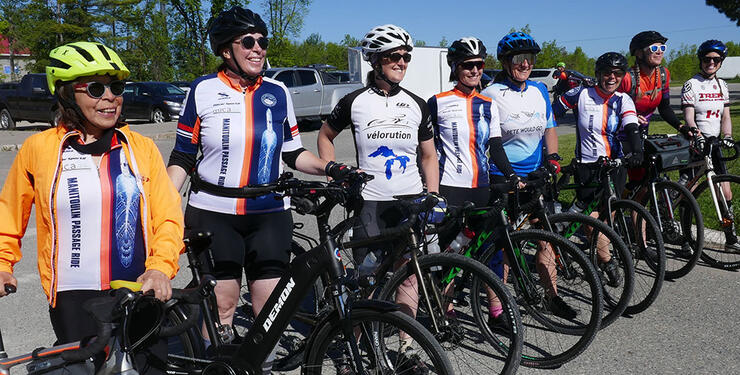 a group of women pose with their bicycles before a Manitoulin cycling tour