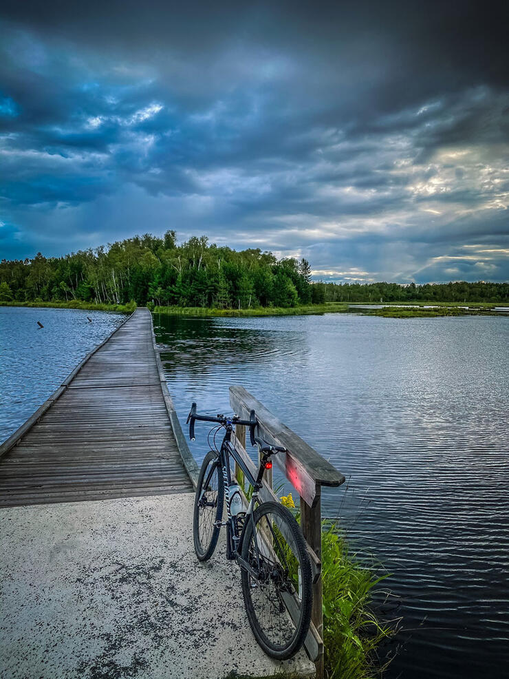 Bike parked at the entrance to a lake boardwalk at Lake Laurentian Conservation Area