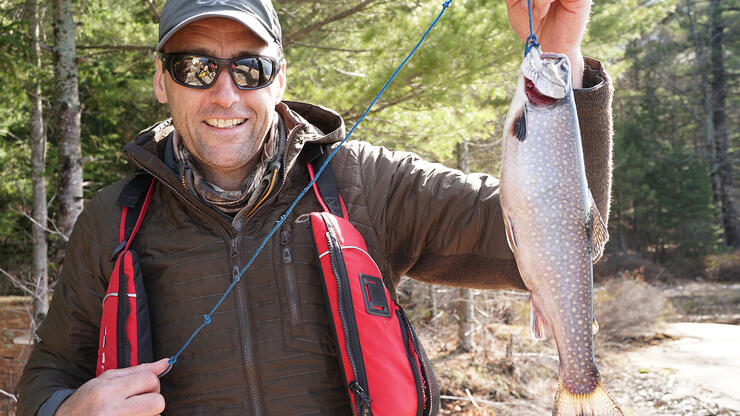 man holding a brook trout