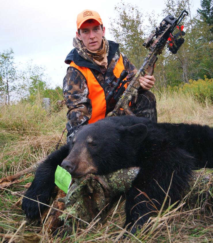 hunter with harvested black bear