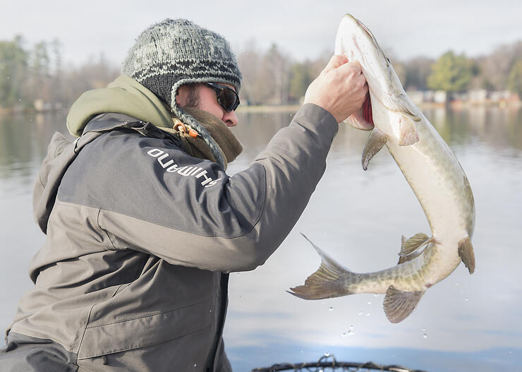 angler holding pike