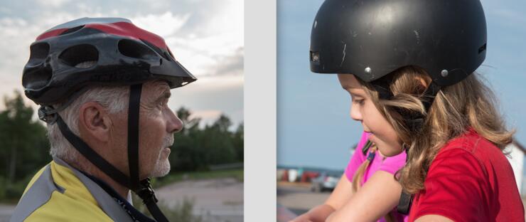 Older man and young girl wearing bike helmets.