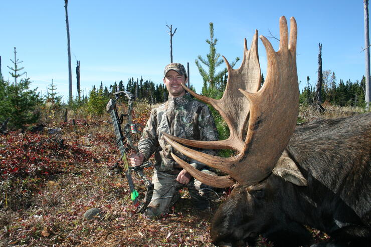 hunter with harvested moose