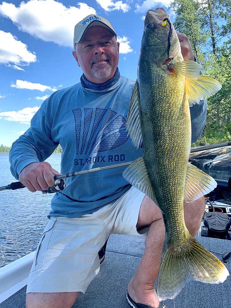 angler holding walleye