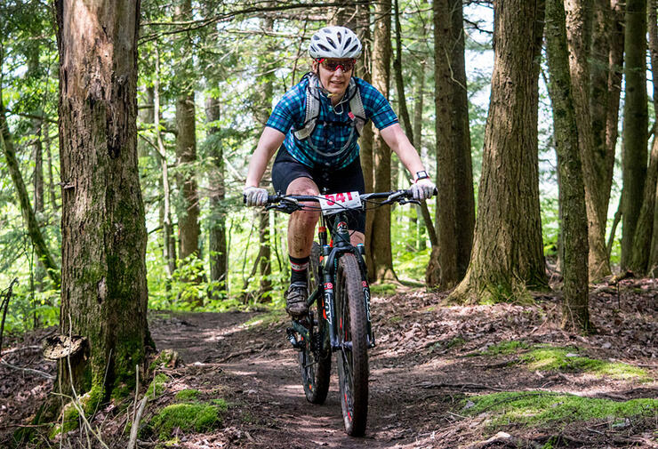 Person on a mountain bike on a forested trail. 