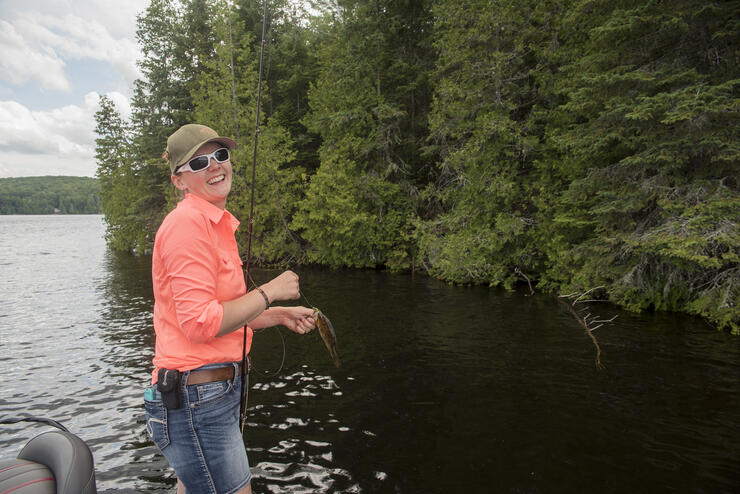 woman angler standing in boat