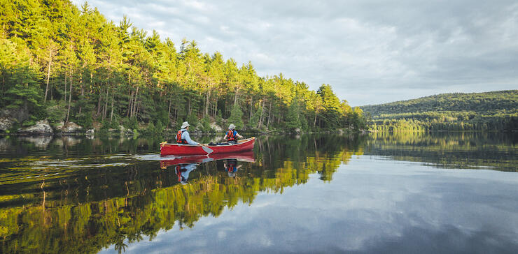 Red canoe on a calm lake 