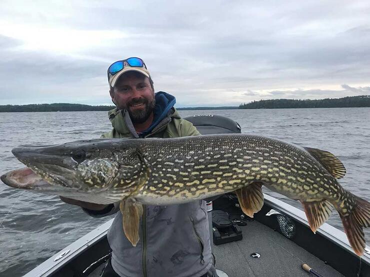 angler fishing northern pike