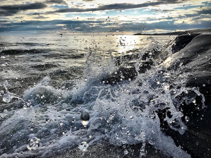 Waves splashing against rocky shore.