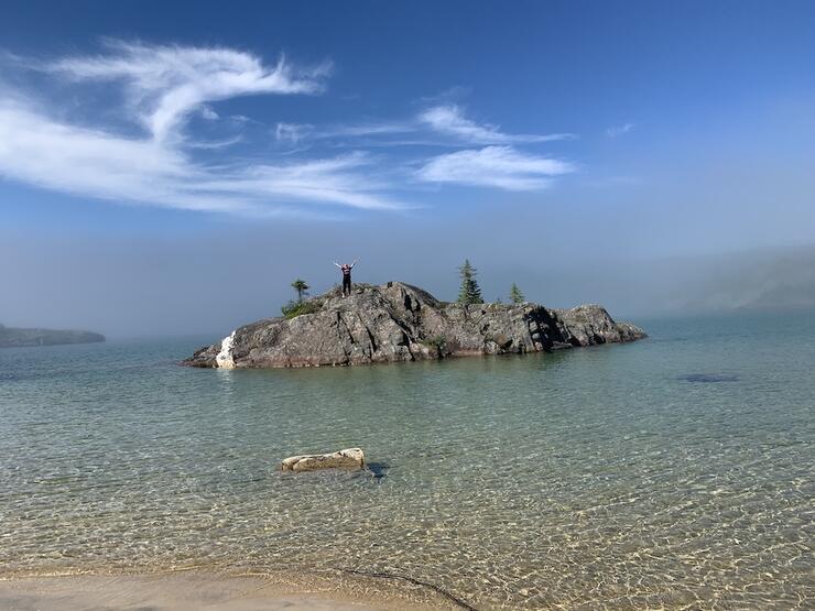 Person standing on rocky island