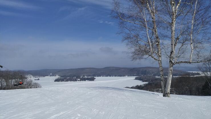 Looking out at frozen lake from top of ski hill.