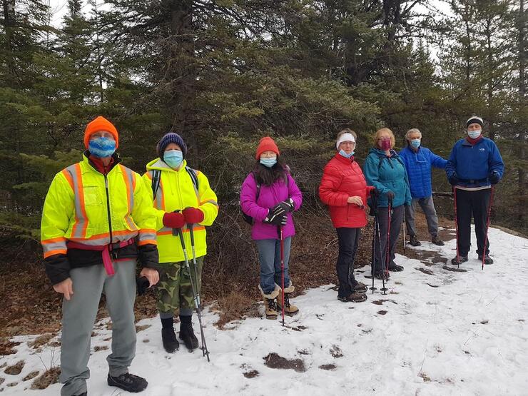 Group of hikers wearing masks in the winter