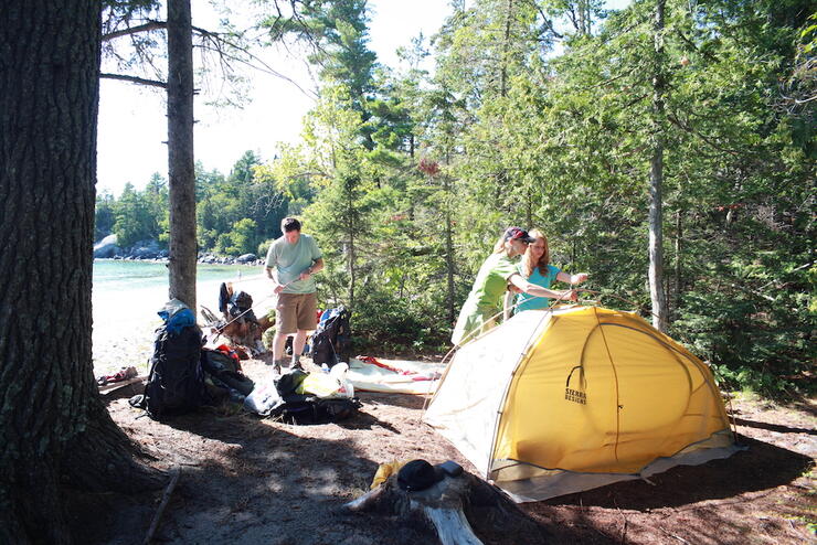 Group of people setting up a tent