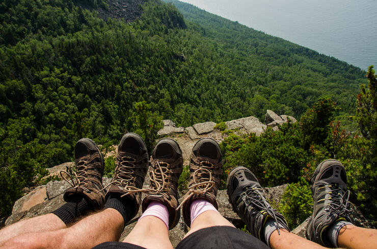 Group of hikers' feet at edge of cliff