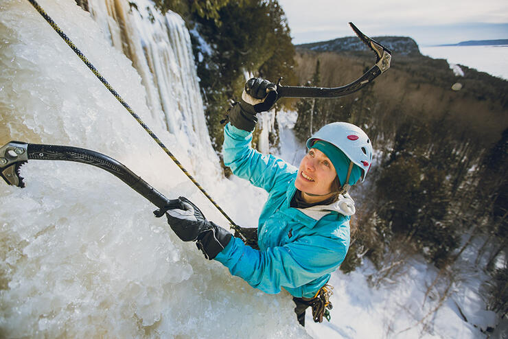 Woman climbing a frozen waterfall.