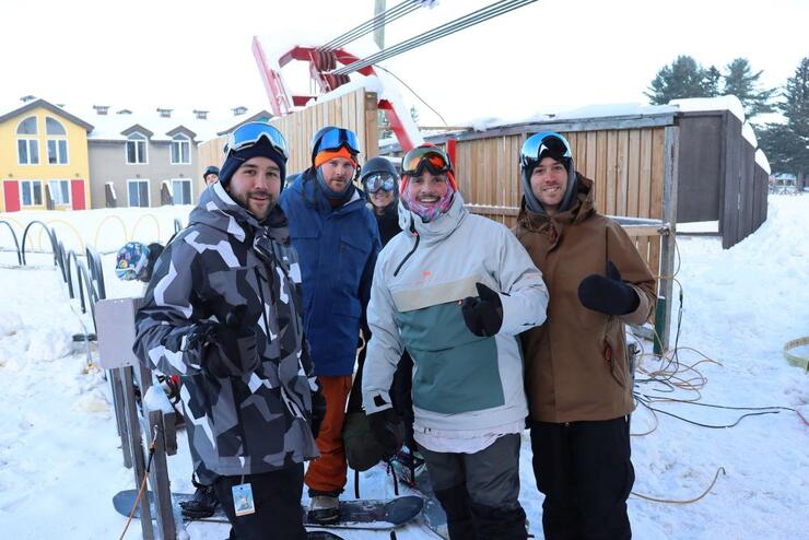 A group poses for a photo before riding the ski lift
