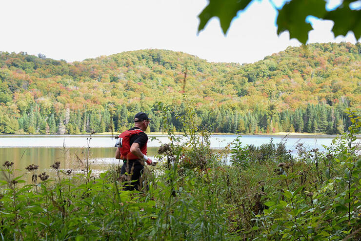 a trailer runner beside a lake at Ultra Trail Stokely Creek in the Algoma Highlands