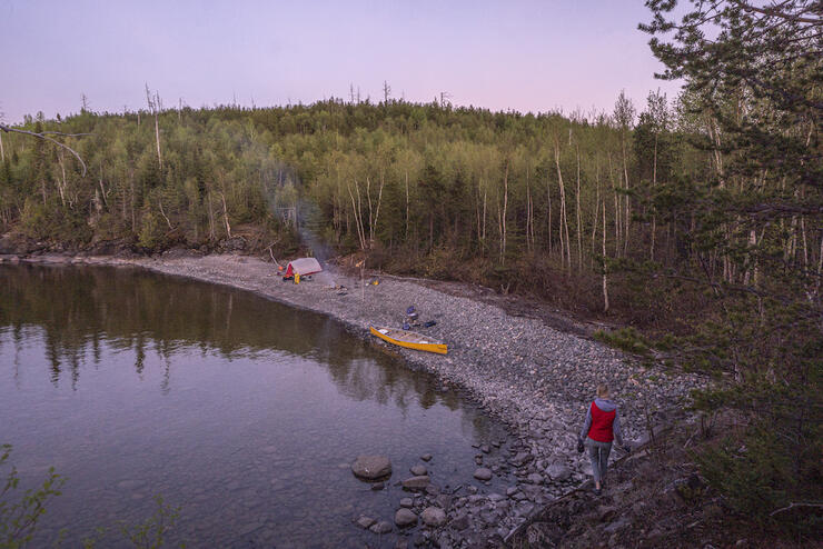 Yellow canoe along a rocky shoreline