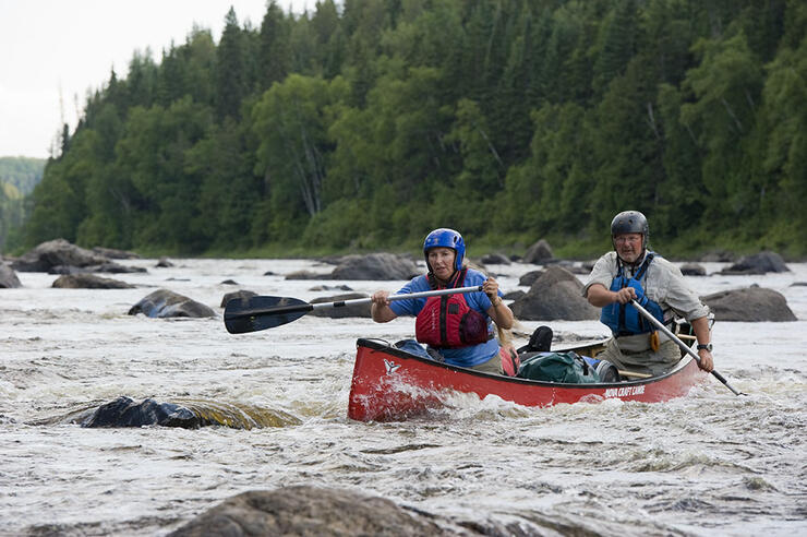 Two People paddling down river