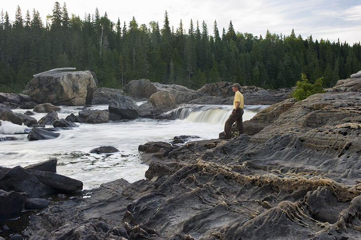 Man standing at edge of the falls