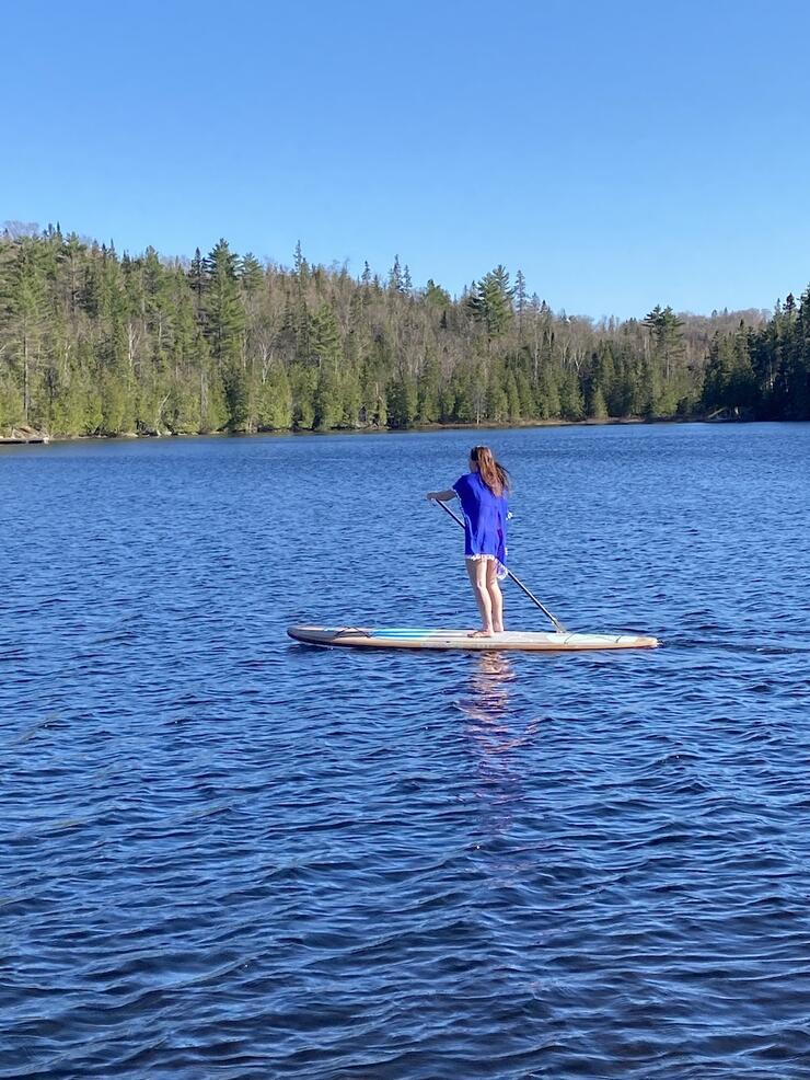Woman paddleboarding on a lake