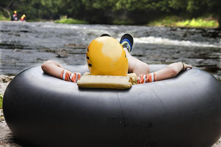 Person lounging in a black inner tube