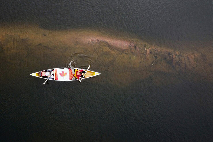 Overhead shot of canoe with Canadian flag in the middle.