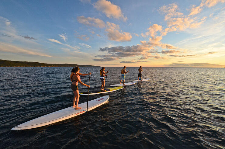 four people paddleboarding on Lake Superior