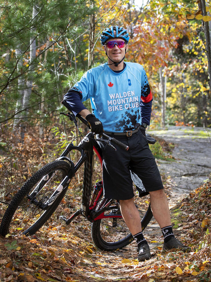 Rusty Hopper poses with his bike on a fall trail near Sudbury