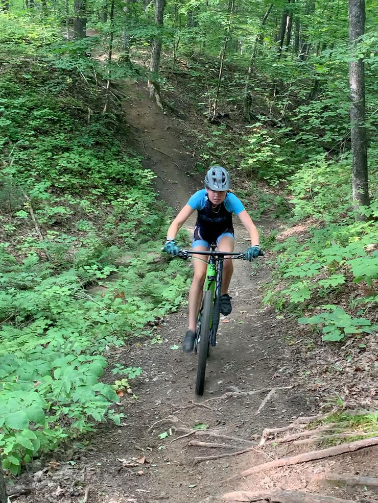 girl rides mountain bike on Hiawatha Highlands trail