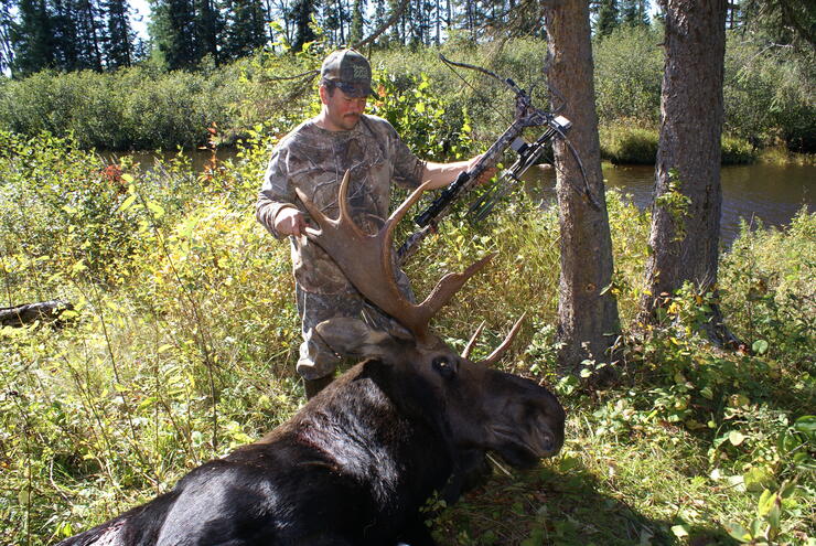 hunter with harvested moose