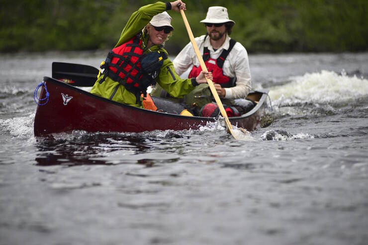 Canoeist doing draw stroke in bow of canoe