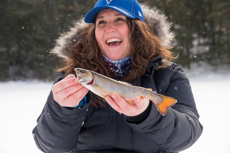 woman angler holding brook trout