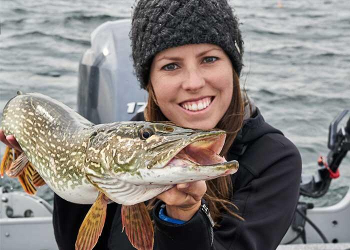 angler holding a northern pike