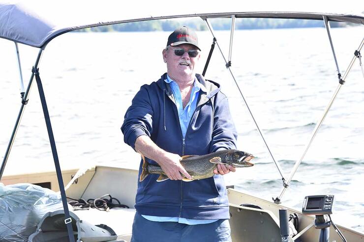 angler holding a lake trout