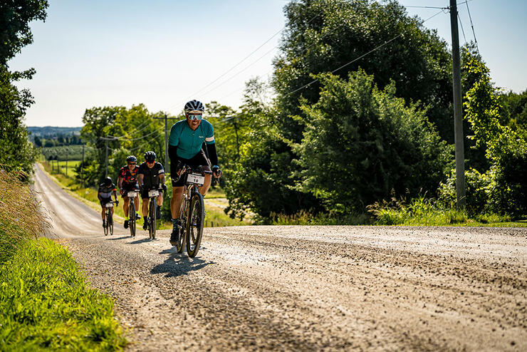 cyclists ride down a gravel road in the Sea Otter Canada road cycling race