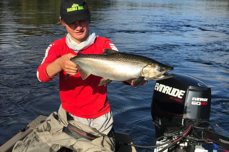 young angler holding steelhead