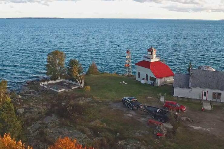 aerial view of bruce bay cottages and lighthouse