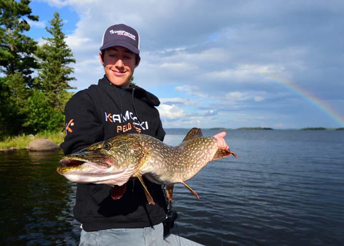 young angler holding ontario northern pike