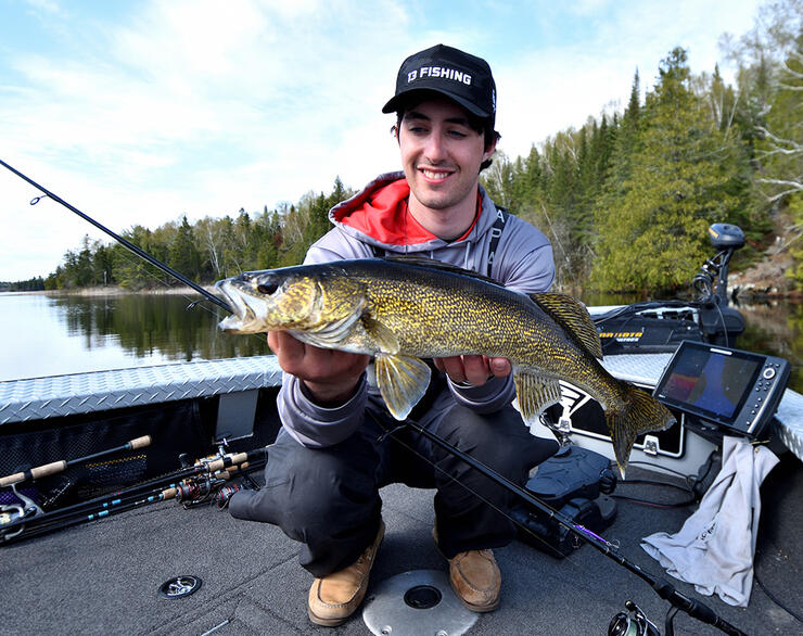 young angler fishing walleye boat