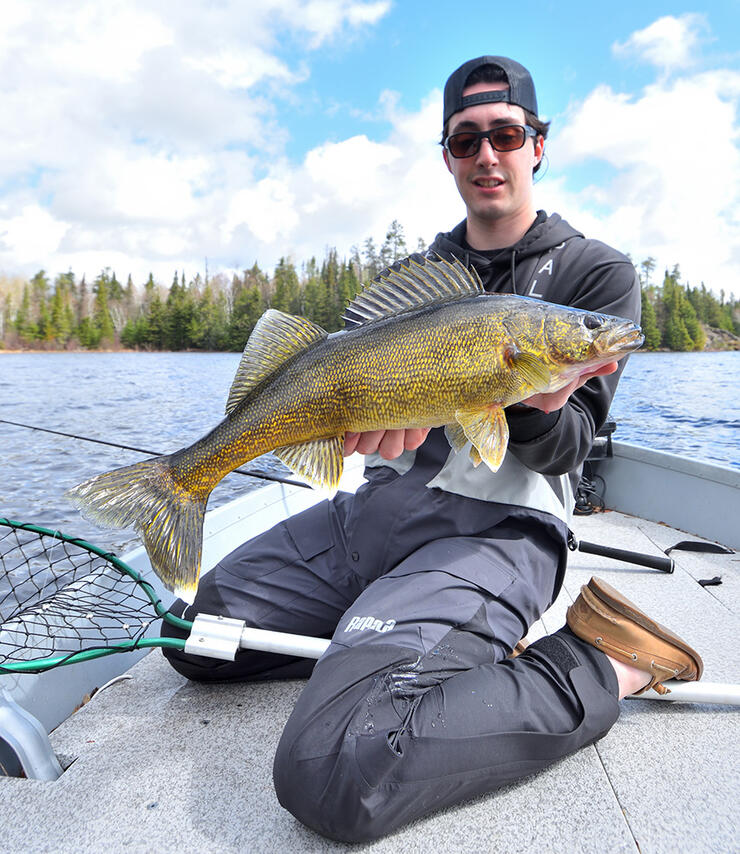 young angler fishing walleye boat