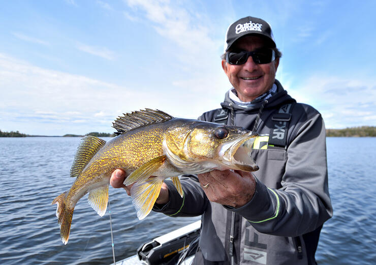 angler fishing ontario walleye in a boat