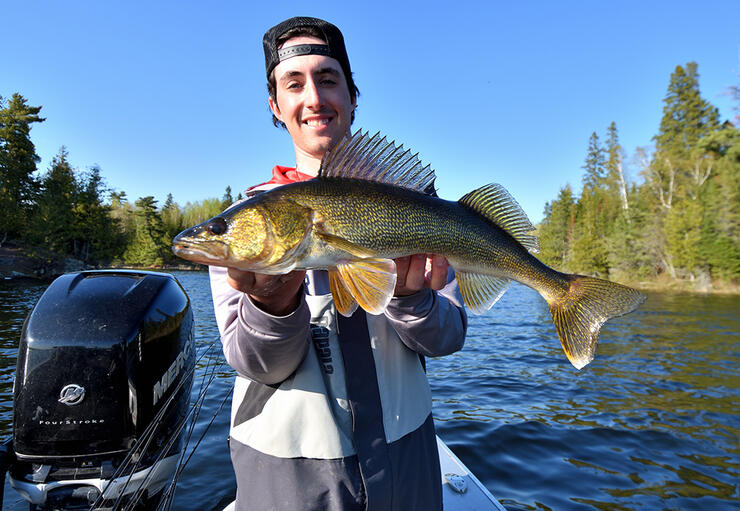 young angler fishing walleye boat